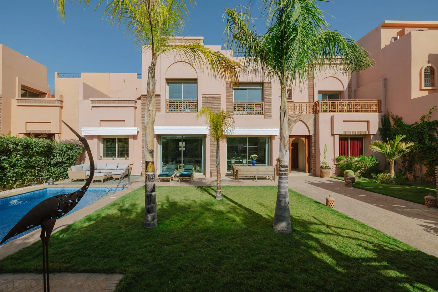 Villa des Arts facade with pool and lawn