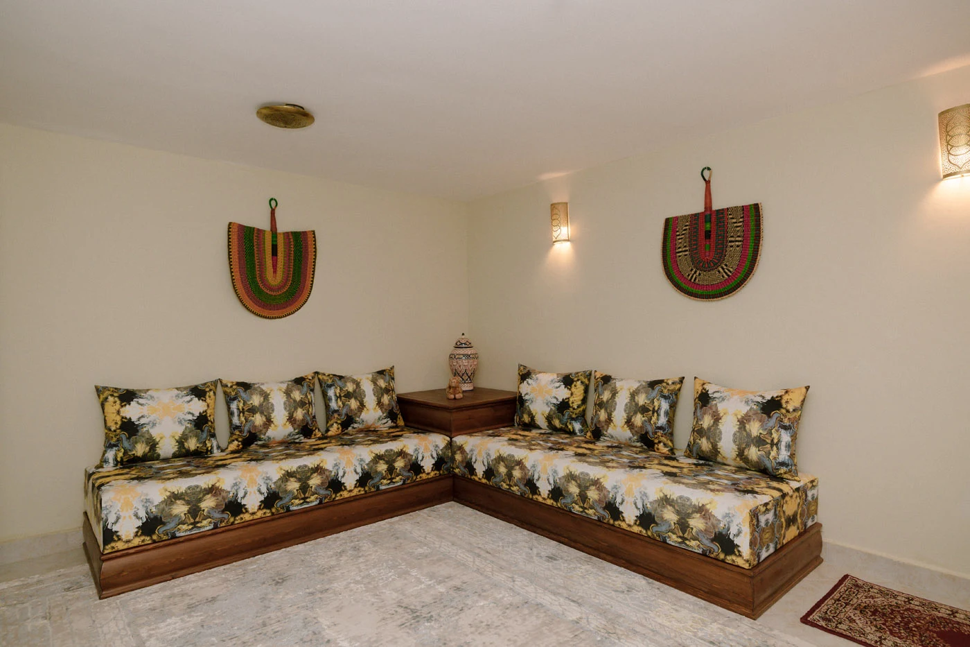 Moroccan lounge with handcrafted cushions and carved furniture