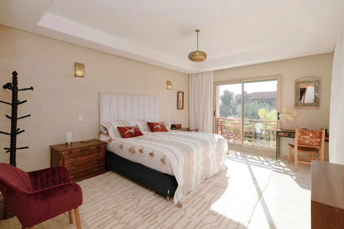 Sunlit master bedroom with balcony curtains