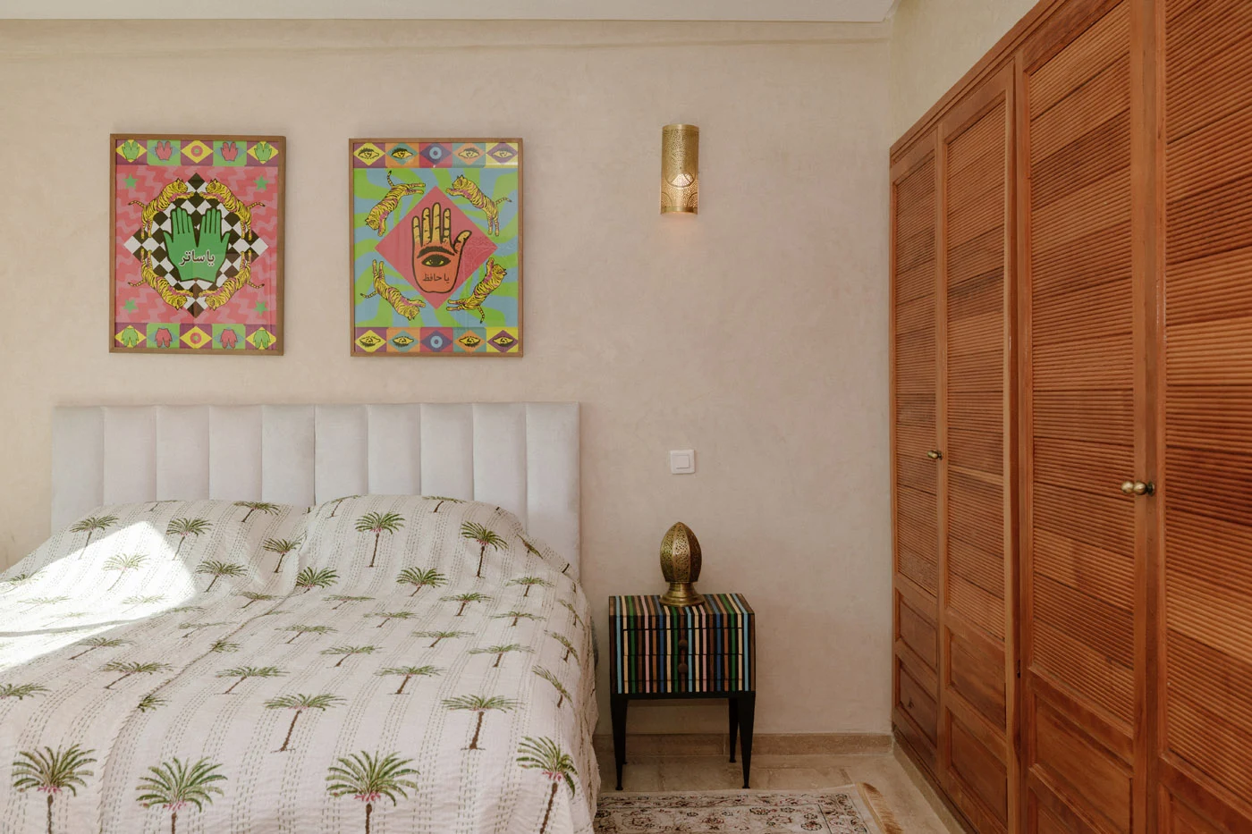 YASALAM artworks displayed above the bedroom headboard