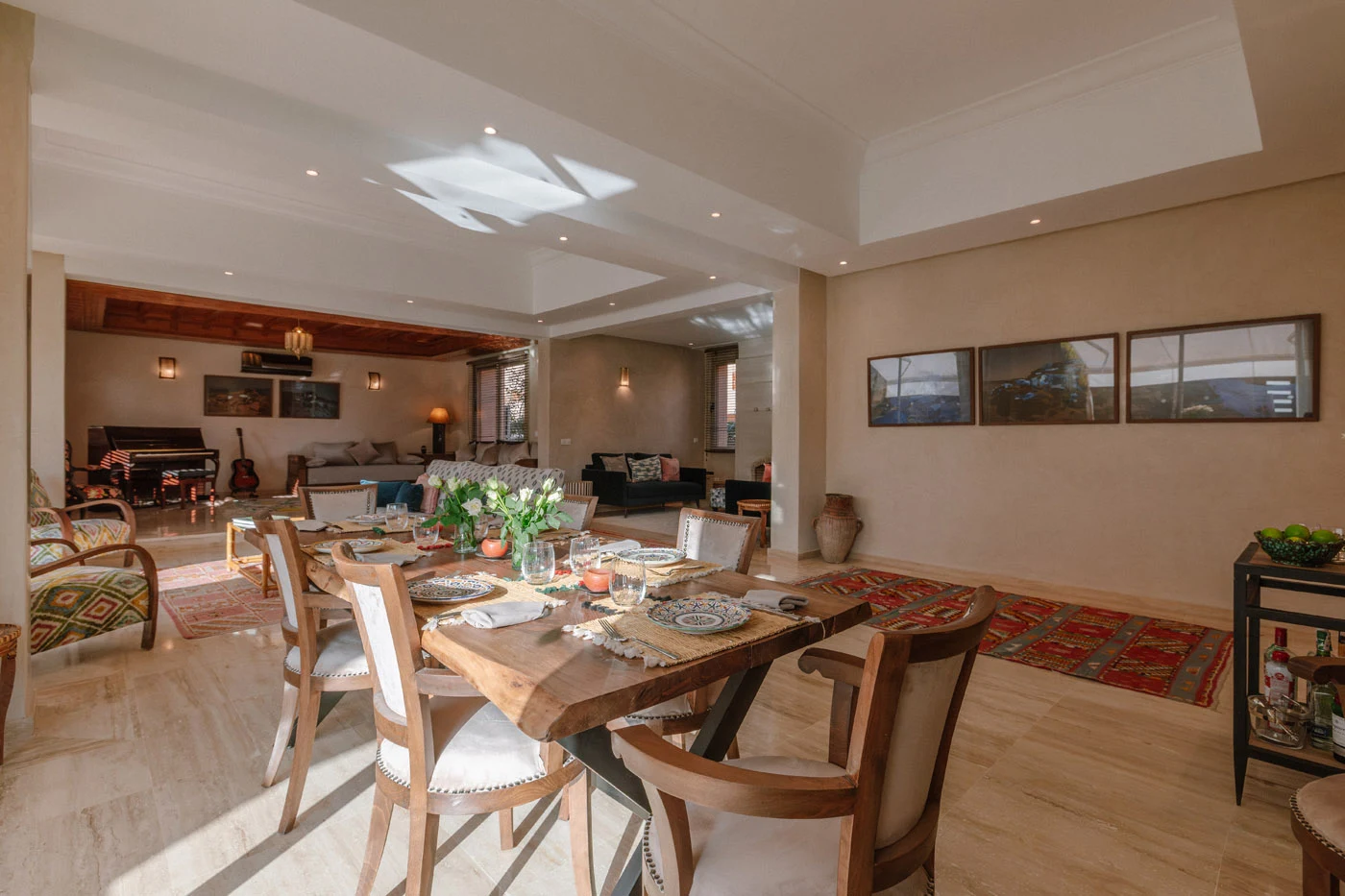 Dining and living space featuring curated artworks and warm textures